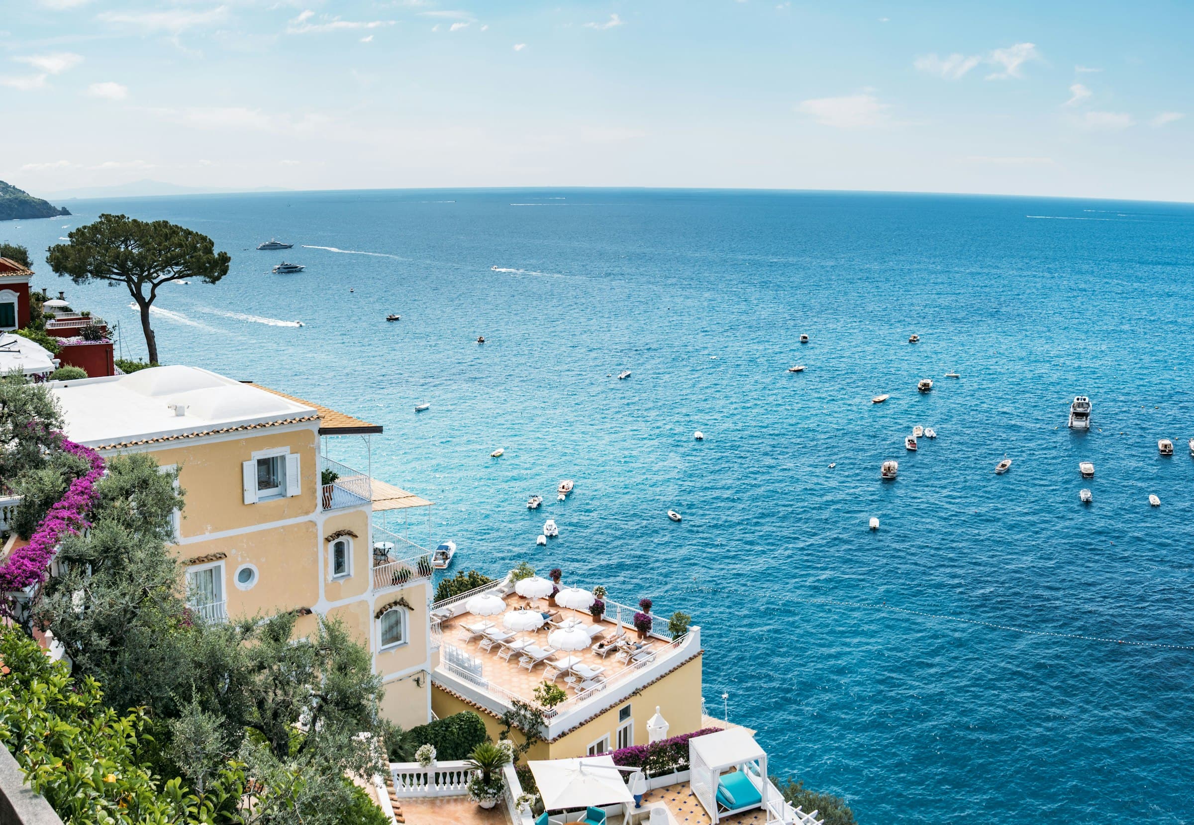 Colourful coastal town buildings overlooking the vibrant blue sea on the Amalfi Coast