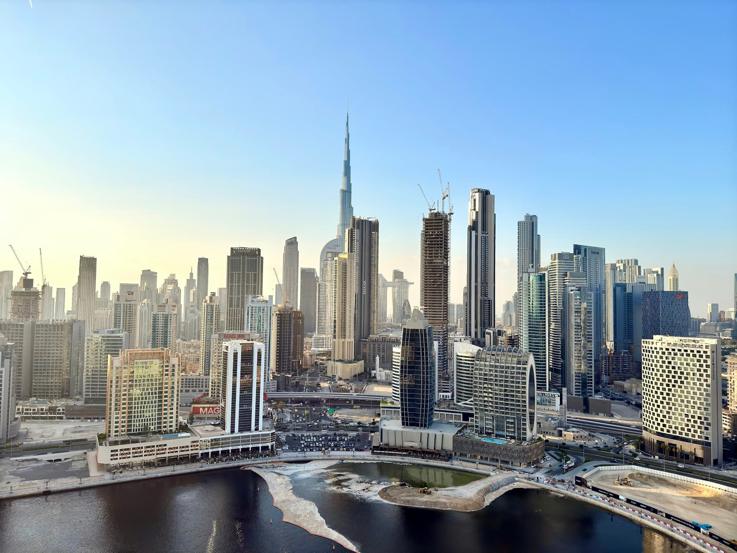 Daytime view of the Dubai skyline with the Burj Khalifa towering above the waterfront