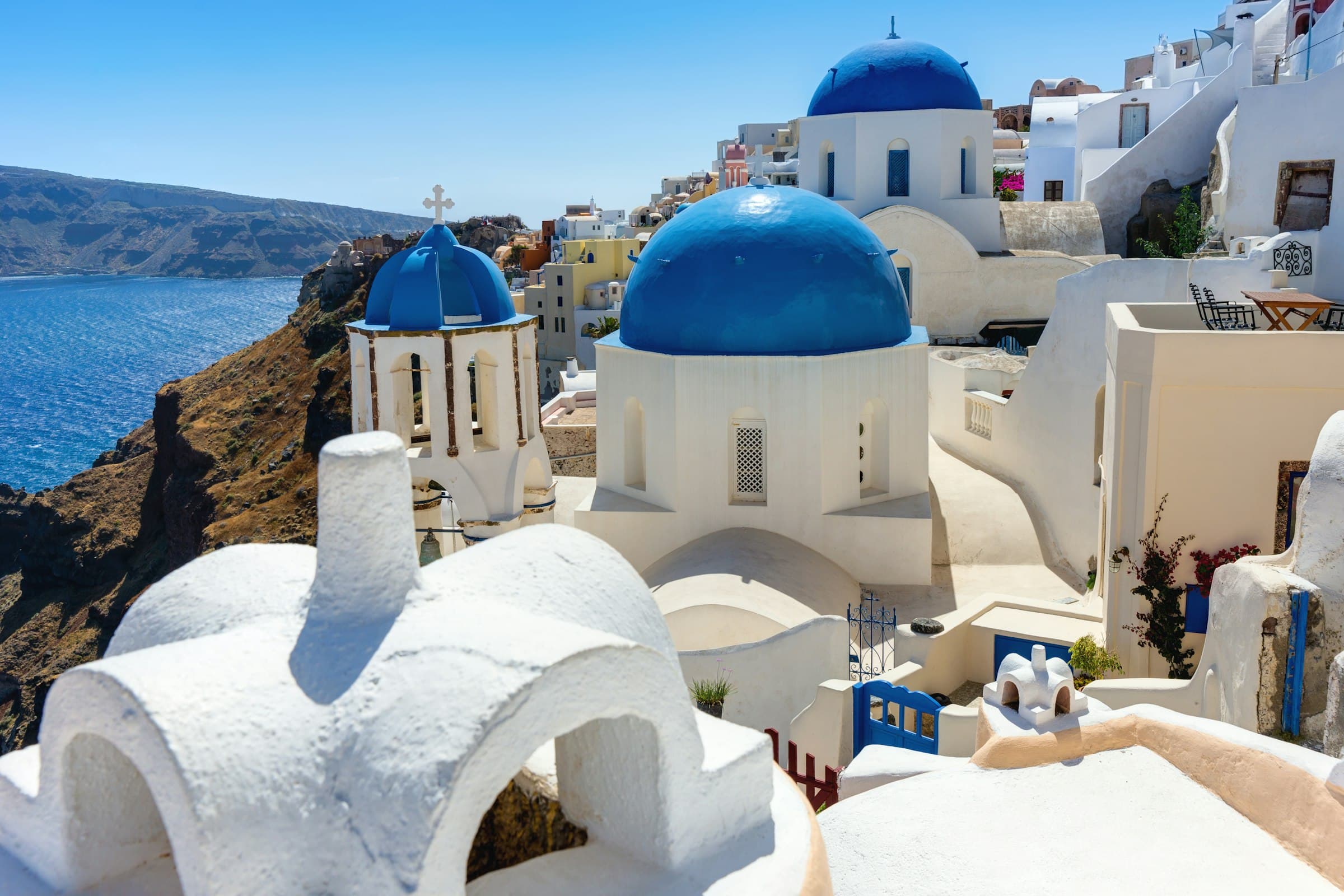 Iconic blue-domed churches and whitewashed buildings overlooking the sea in Santorini