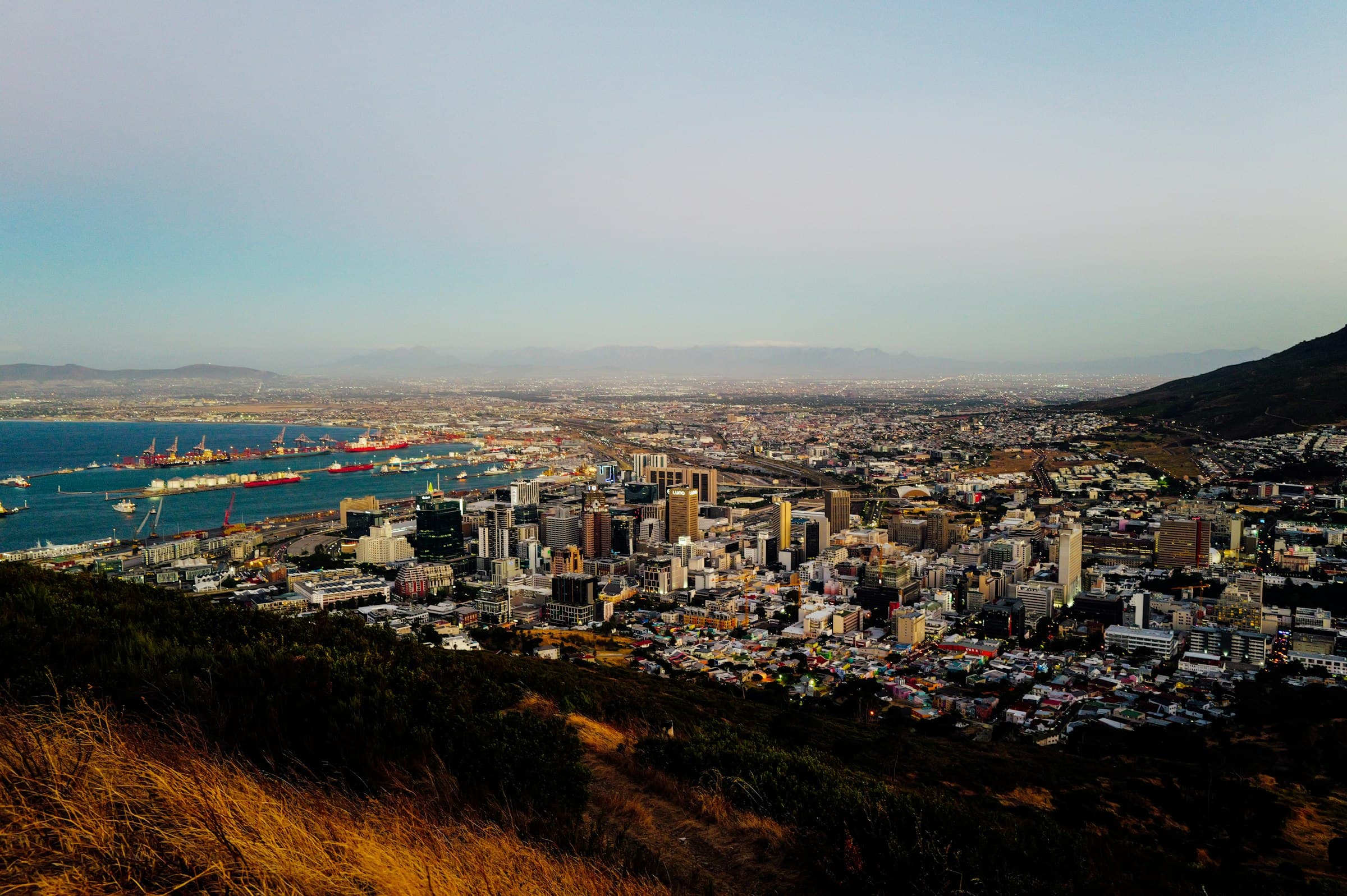 Panoramic view of a South African coastal city with a busy harbour and mountain backdrop