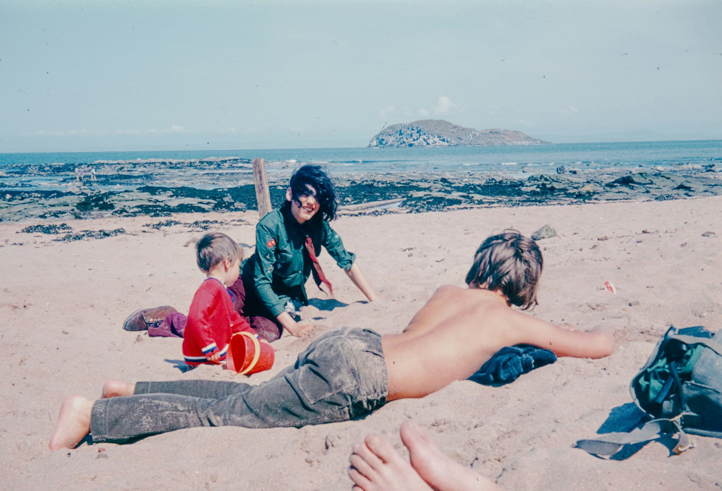 A family relaxing together on a beach on a sunny day