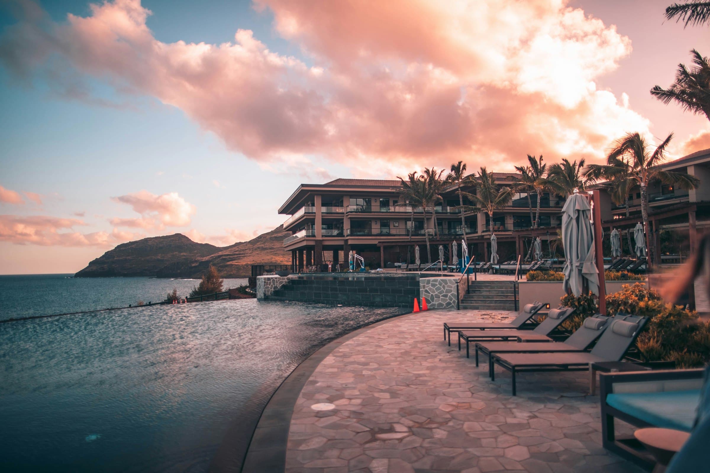An elegant infinity pool along the edge of a luxury hotel building